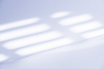 Studio style background wall decoration presentation uses white and blue tones. with shadows cast from a nearby window, concept creating a decorative backdrop.