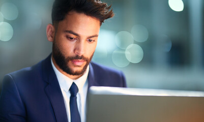 Thinking, serious and man in night, laptop and test of software for cybersecurity, programmer and bokeh. Late, overtime and employee for coding of website, IT and information technology in dark