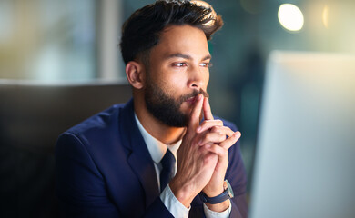Business, man and thinking with computer in office for problem solving, trading solution or stock market ideas. Professional, trader or planning at night with cryptocurrency contemplation or review