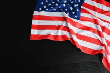 Obraz premium Flag of USA on black wooden table, top view. Space for text