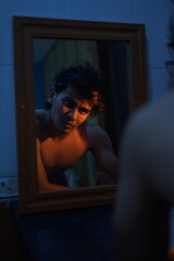 MAN LOOKING AT THE MIRROR