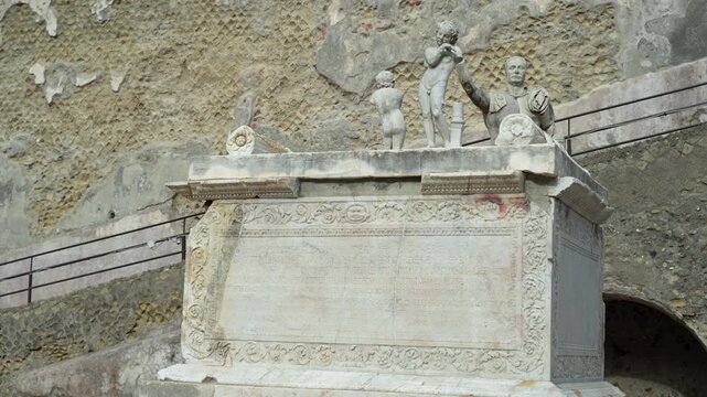 Ancient Roman monument inscribed with Latin at the historic walls of the town of Herculaneum in Italy.