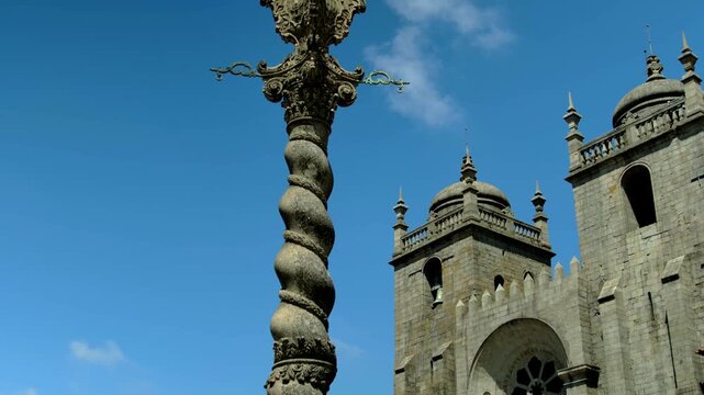 A spiral thing in the middle of a fountain by a cathedral in Porto, Portugal.