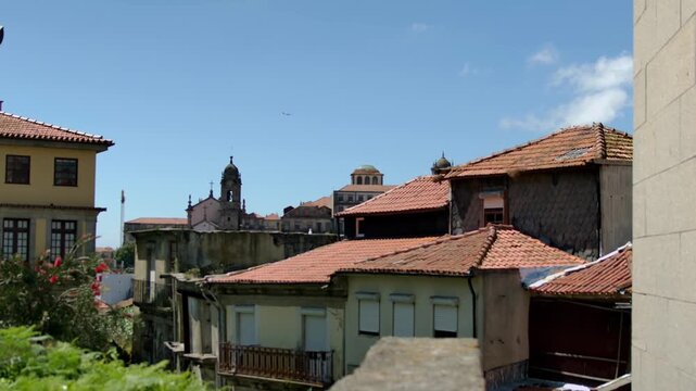 A seagull, landing on the roof of a building.