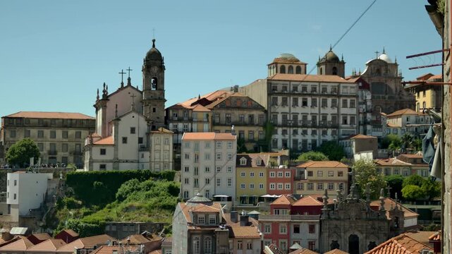 A view in Porto, Portugal. With some clothes haning on a line by a window and waving in the wind.