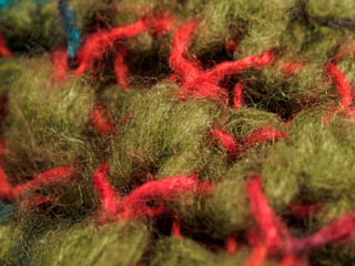Close-up of brightly colored knitted wool fabric. Detailed textures and rich colors create a cozy and inviting image, ideal for showcasing the quality and style