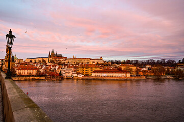 Prague at sunrise over the famous Charles Bridge Karluv most with panoramic view of the historic Prague Castle Prazsky hrad early morning with beautiful sky, Prague, Czech Republic