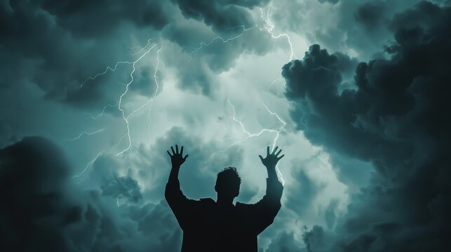 A silhouette of a man with arms raised facing a stormy sky with lightning, symbolizing strength, resilience, hope, courage, and defiance.