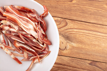 A plate of cut pig ears on the table