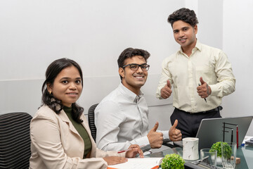 Young Indian Professionals in a Successful Startup Team, Using Digital Tablets Celebrating Team...