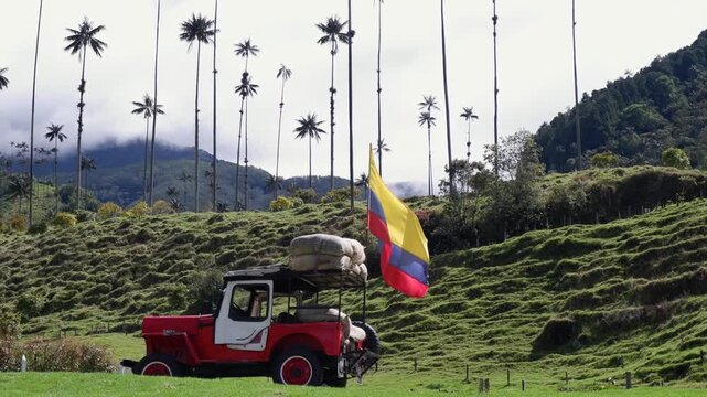 Red Jeep loaded with coffee beans and Colombian flag in Cocora Valley