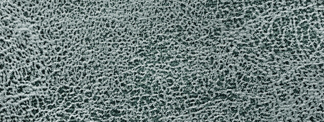 Dark green background fabric with wavy pattern, closeup. Velvet texture emerald textile, macro.