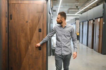 Buyer chooses door in store. Shop window of doors. A large selection of doors for house