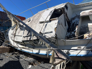 Destroyed yacht from tsunami seismic sea wave.