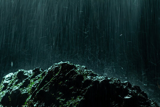 Creative and artistic composition in the Cueva del Esplendor, cave of splendor, Jardin, Jard&iacute;n, Antioquia, Colombia. Dark abstraction with rain falling on a rock and droplets in a ray of light.