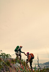 Space, helping hand and friends hiking with support for climbing on mountain or hill in nature....