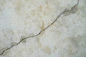 Cracked concrete wall in gray