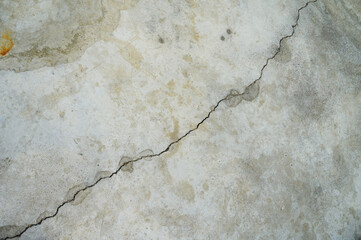 A big crack on an old, rotten wall