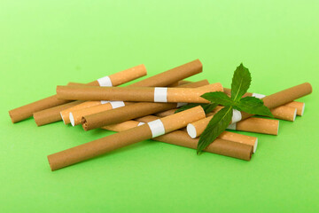 Menthol cigarettes and fresh mint leaves on colored background, Many cigarettes stacked together top view flat lay