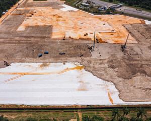 Aerial view of construction site ground process, showing progress in development in Malaysia.