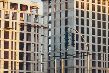 traffic light at an intersection in the middle of a cityscape in new construction area....
