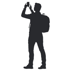 Silhouette of a man with a backpack taking a photo.