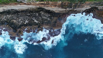 ocean waves crashing on a cliff