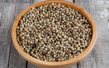 close shot of a wooden bowl of coriander seeds