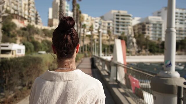 Traveler Walking Along The Promenade Of Saint Paul's Bay, Island of Malta. Slow Motion Shot