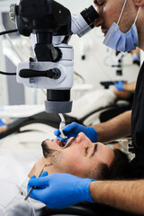 Polishing teeth with digital microscope in stomatology clinic. Digital microscope diagnostic by...