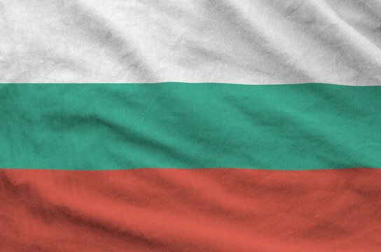 Bulgaria flag depicted on folded wavy fabric of old cloth close up - Powered by Adobe