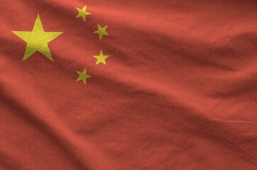 China flag depicted on folded wavy fabric of old cloth close up