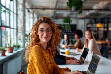 Professional office environment with a diverse team working on laptops and digital devices