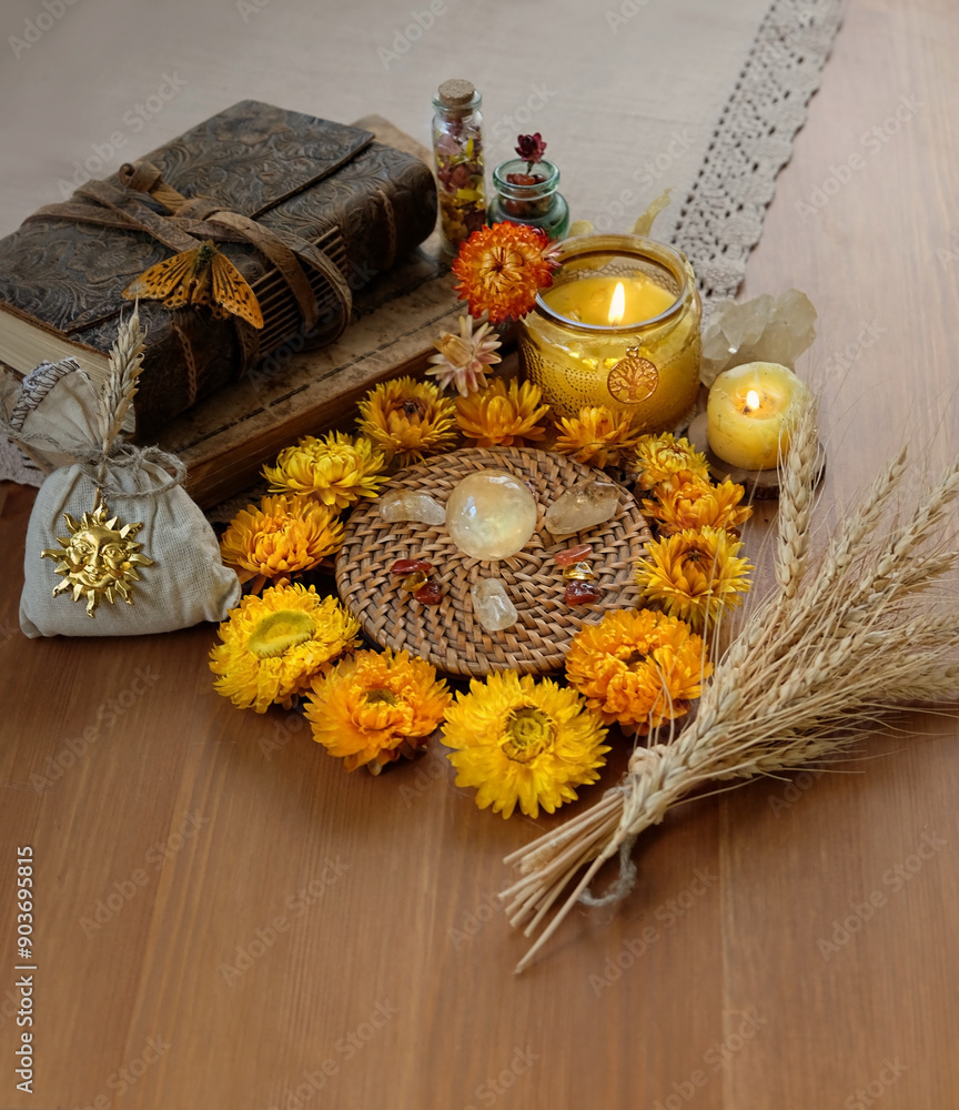 Wall mural amulets, candles, witchcraft items, spell books, wheat ears and crystals on table. wiccan witchcraft