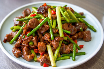 A delicious Chinese home-cooked dish, stir-fried beef with garlic sprouts