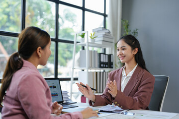 Asian female sales representatives in the section of Real estate talked and discussed tax plans to search for information Ask questions and give advice. All information is recorded and detailed.