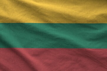 Lithuania flag depicted on folded wavy fabric of old cloth close up