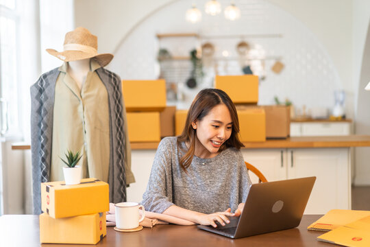 Portrait of owner asian woman freelancer sme business online shopping working checklist order and packing product, cardboard box, E-commerce, marketing, entrepreneur, Business online, startup concept