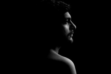 Dramatic portrait of a young guy on a black background, black and white photography, Dramatic Portrait, Light, Study of light