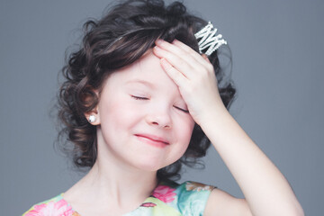 Little girl dressed as a princess after making a mistake.