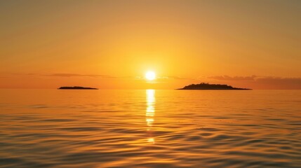 Obraz premium Golden sun setting behind distant islands and calm waters