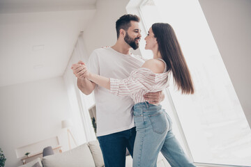 Photo of two idyllic partners cuddle dancing modern bright interior weekend flat indoors