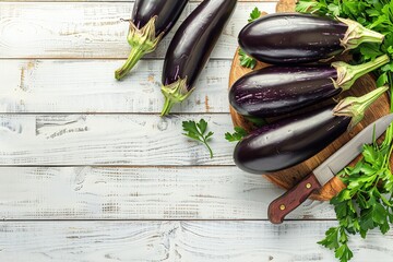 Fresh eggplants with  leaves on a cutting board