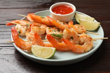 Skewers with delicious grilled shrimps served on wooden table