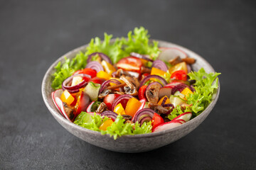 Easy vegetarian salad of fresh cucumber, mushrooms, tomato, sweet pepper, radish and onion in bowl . Healthy food.