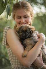 A photo of a beautiful girl with a small puppy.