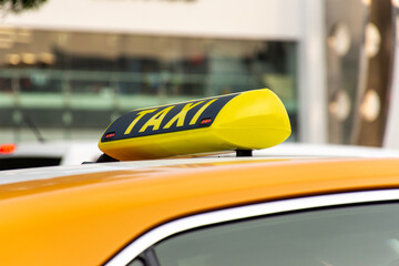 Close-up of yellow taxi car sign in Dubai City, UAE.