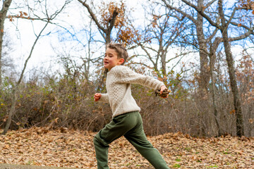 Boy running in nature in autumn