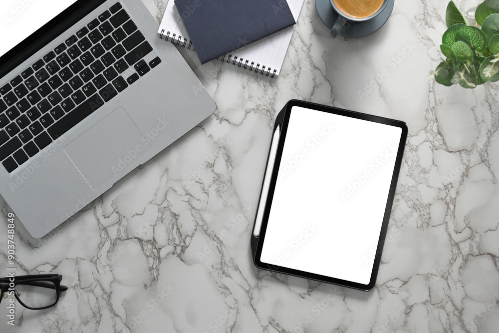 Wall mural top view of creative working desk with digital tablet, laptop and notebook on marble table