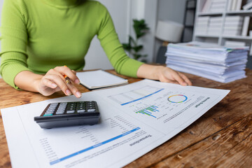 Business financing accounting banking concept. Business woman hand doing finances and calculate on desk about cost at home office. Woman working on desk with using calculator, finance accounting.